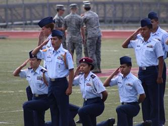 People in military uniforms saluting