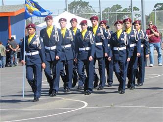 Students in dress uniforms marching